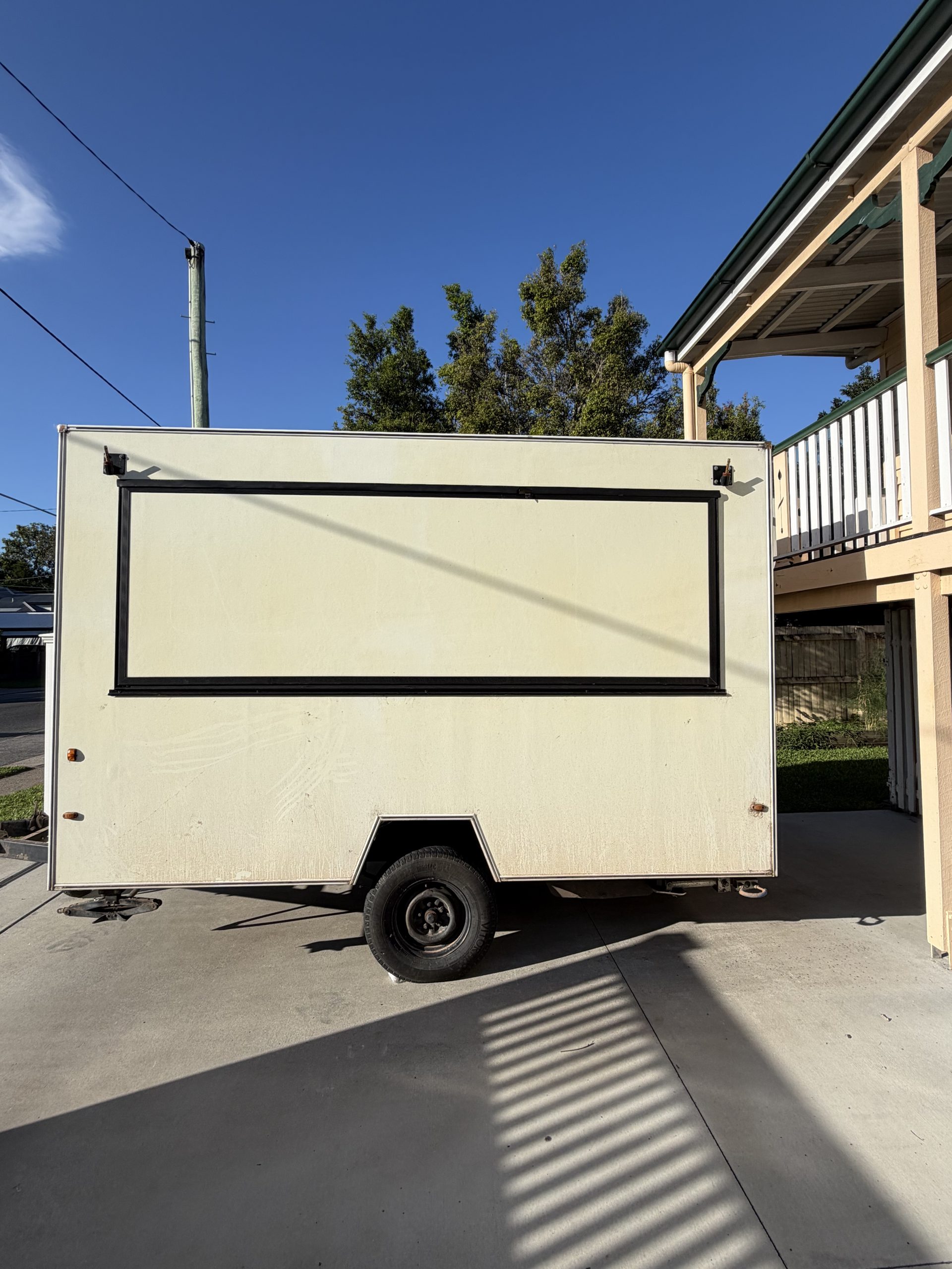 Food trailer before mural — blank white trailer